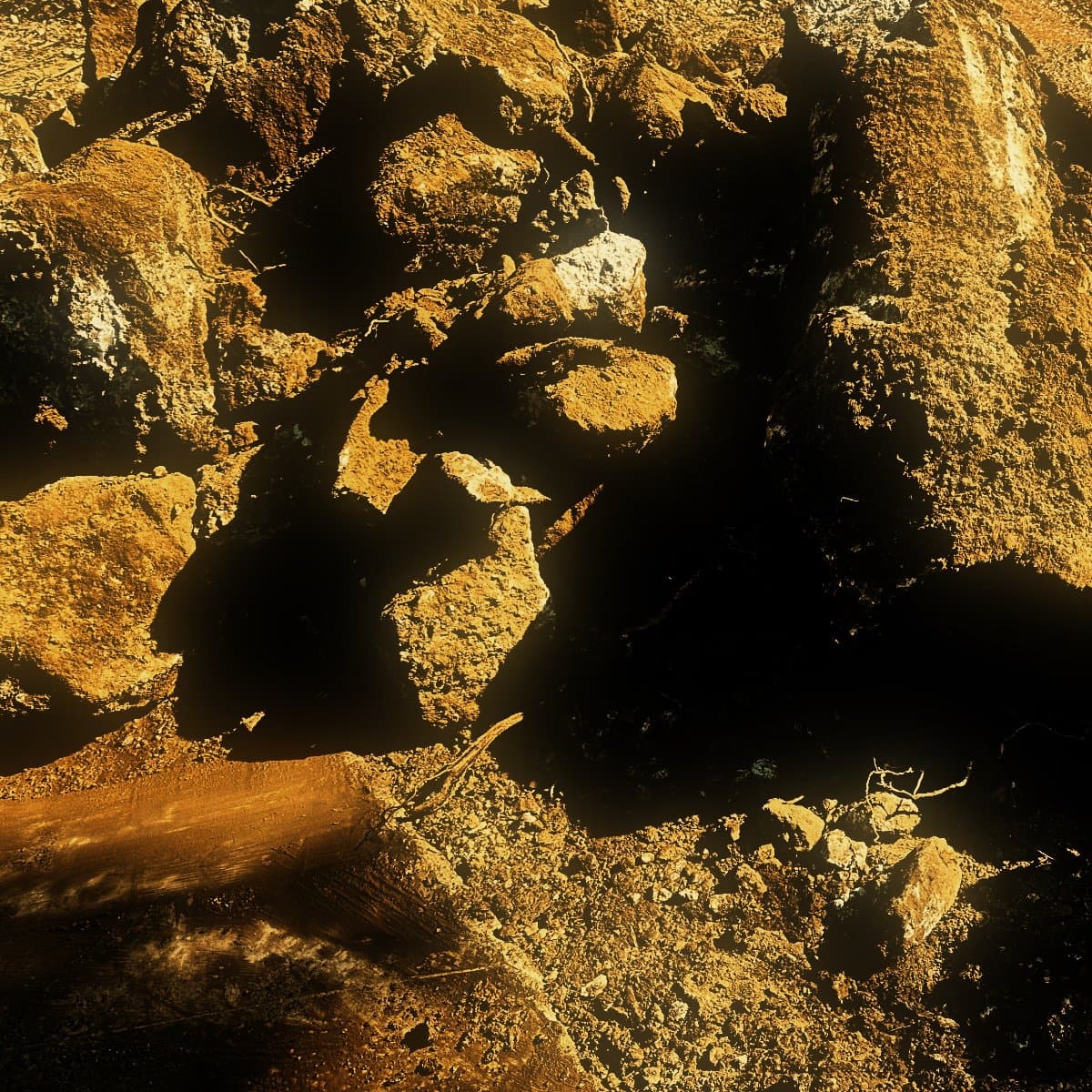 Boulders broken out of a hillside cut and left in a pile, reduced small enough for a machine to lift