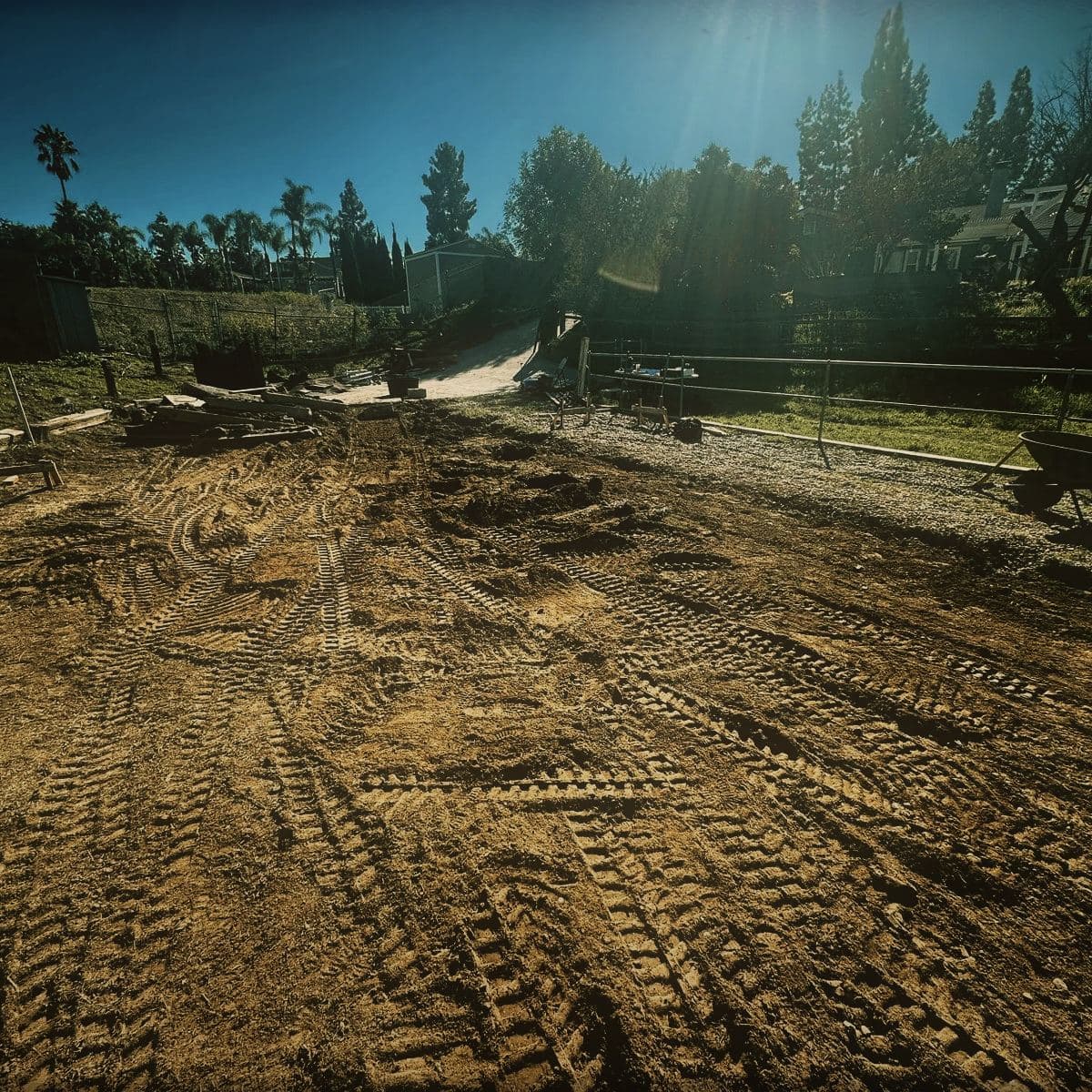 A cleared and graded building pad in Simi Valley, tracked out by machine and ready for setting out