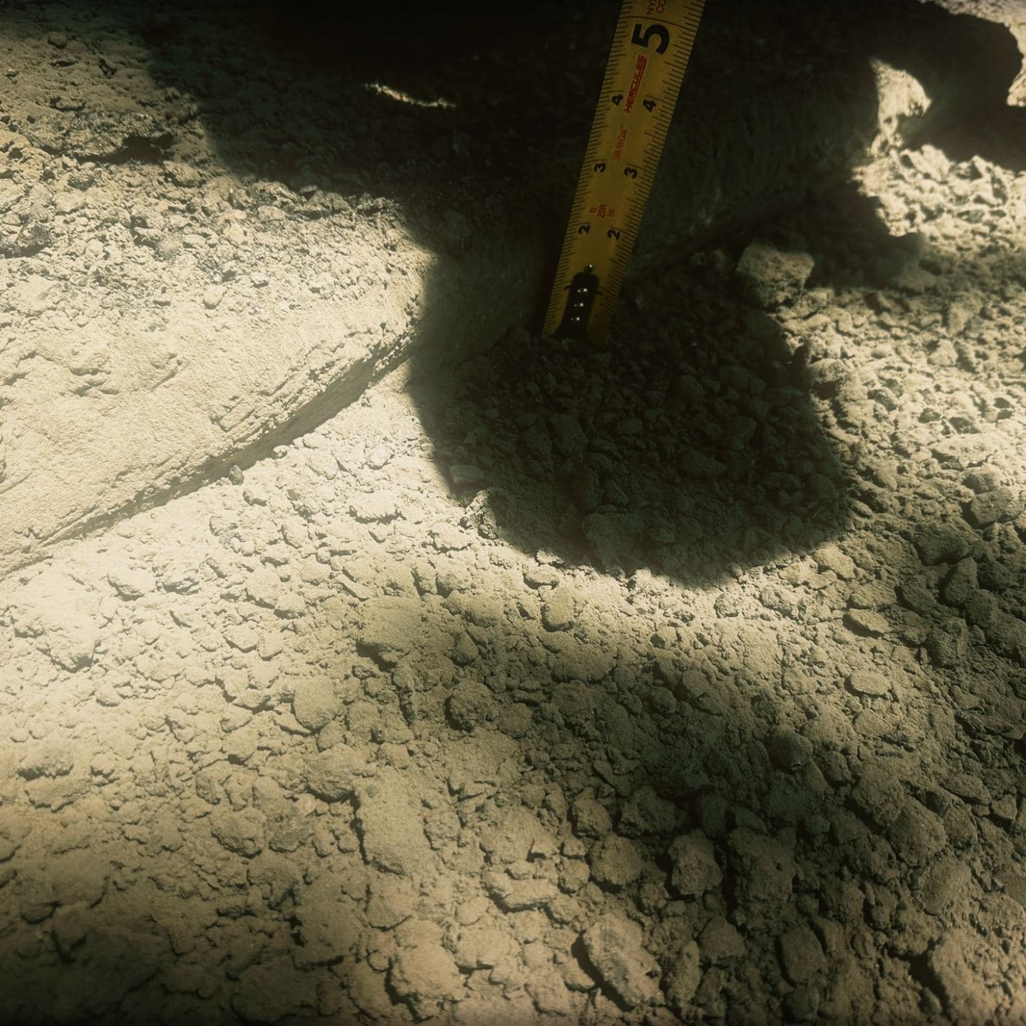 A tape measure stood upright in the excavated asphalt section at Westmount to check the depth of the cut before the patch is placed