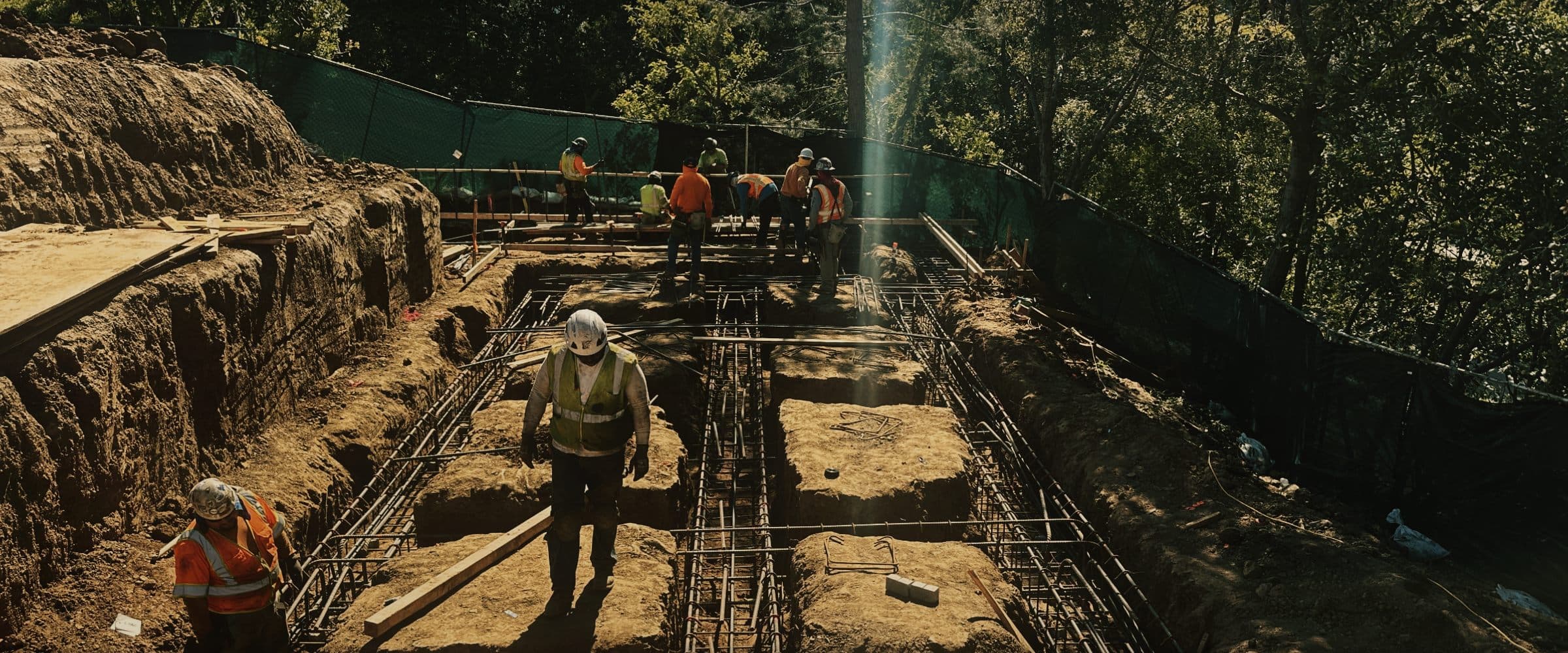 EMAE & Sons crew working in a hillside excavation in Brentwood, formwork trenches running to depth