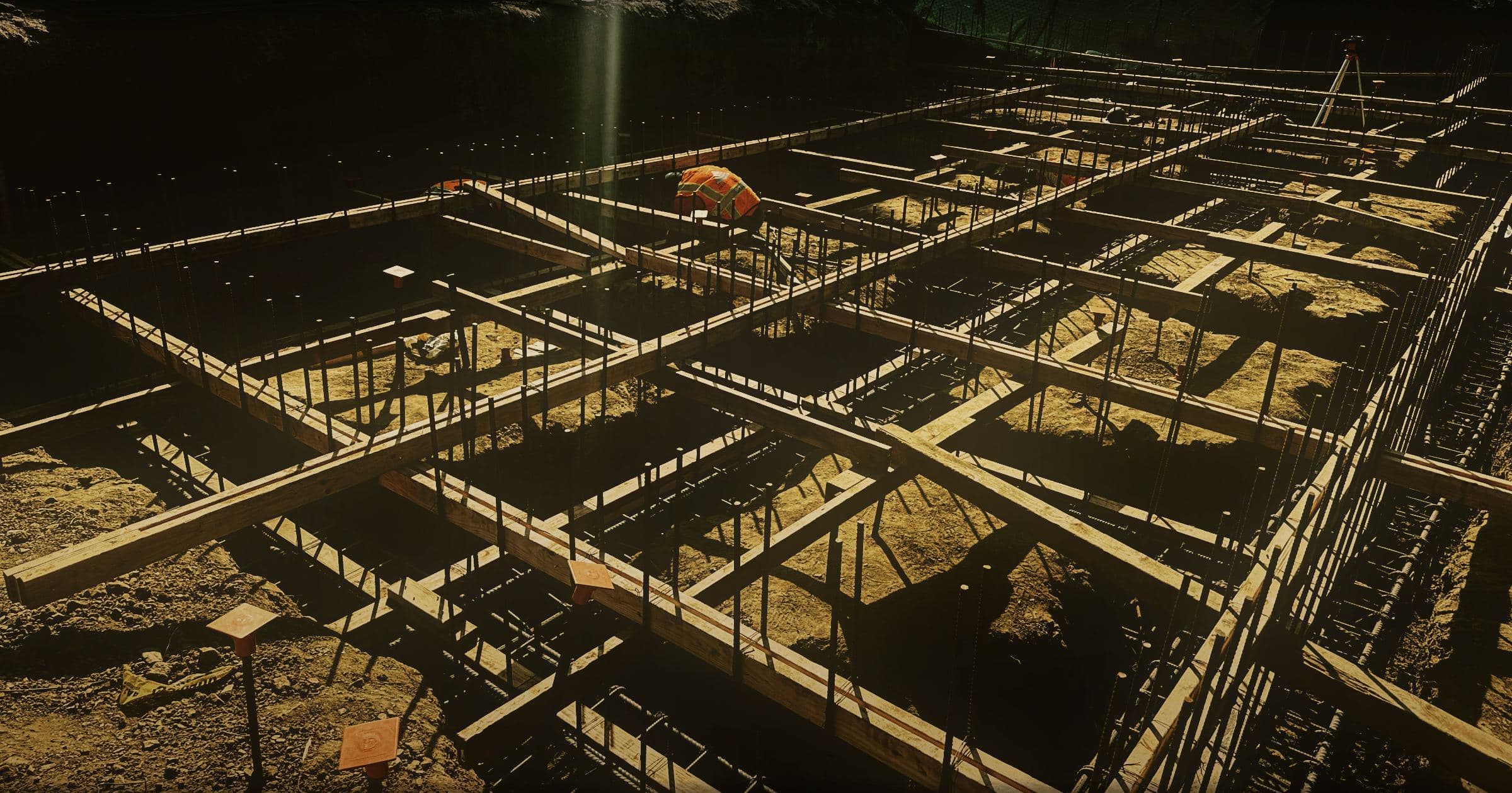 The full building footprint cut into the Brentwood hillside, grade beams formed in timber with reinforcing steel set through every run