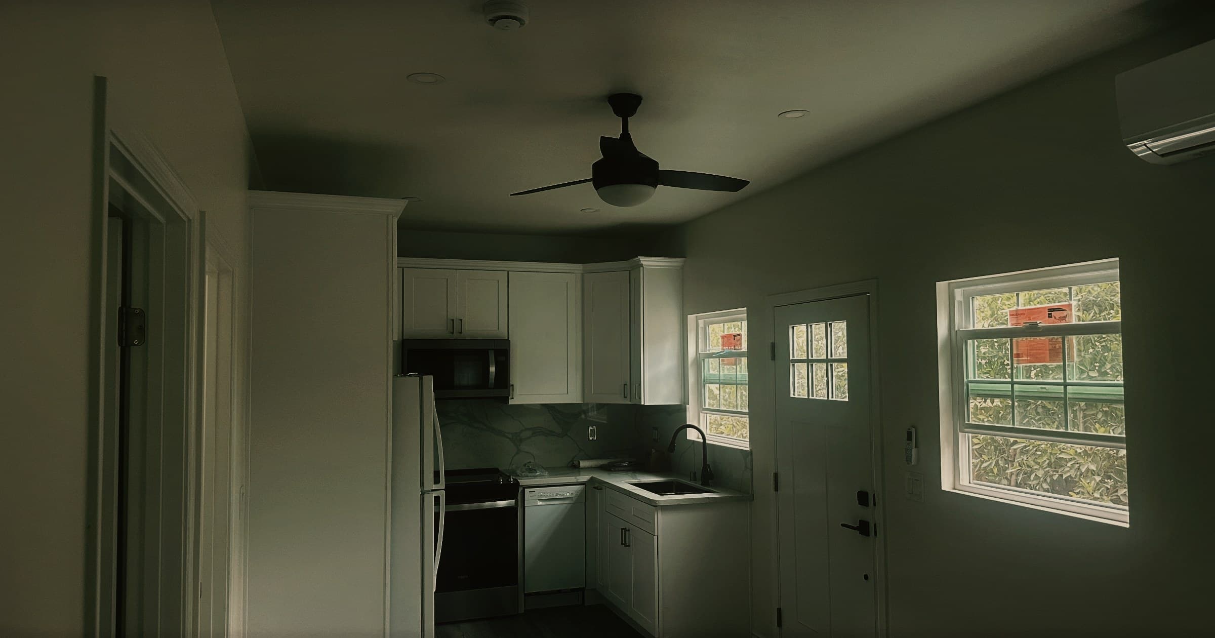 The living space of a completed detached accessory dwelling unit, looking across to the kitchen and the entrance door